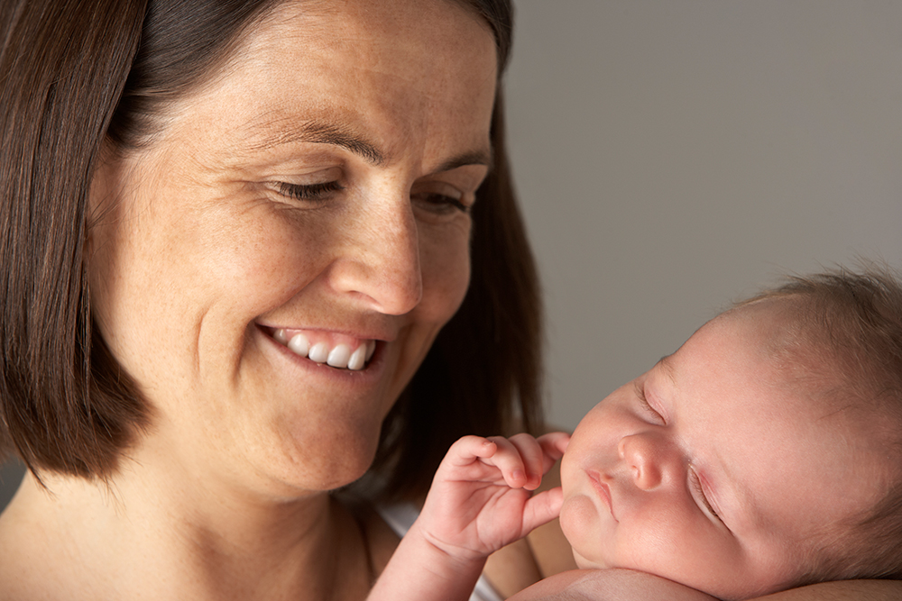 happy woman with newborn - happy birthing days - elements of birth