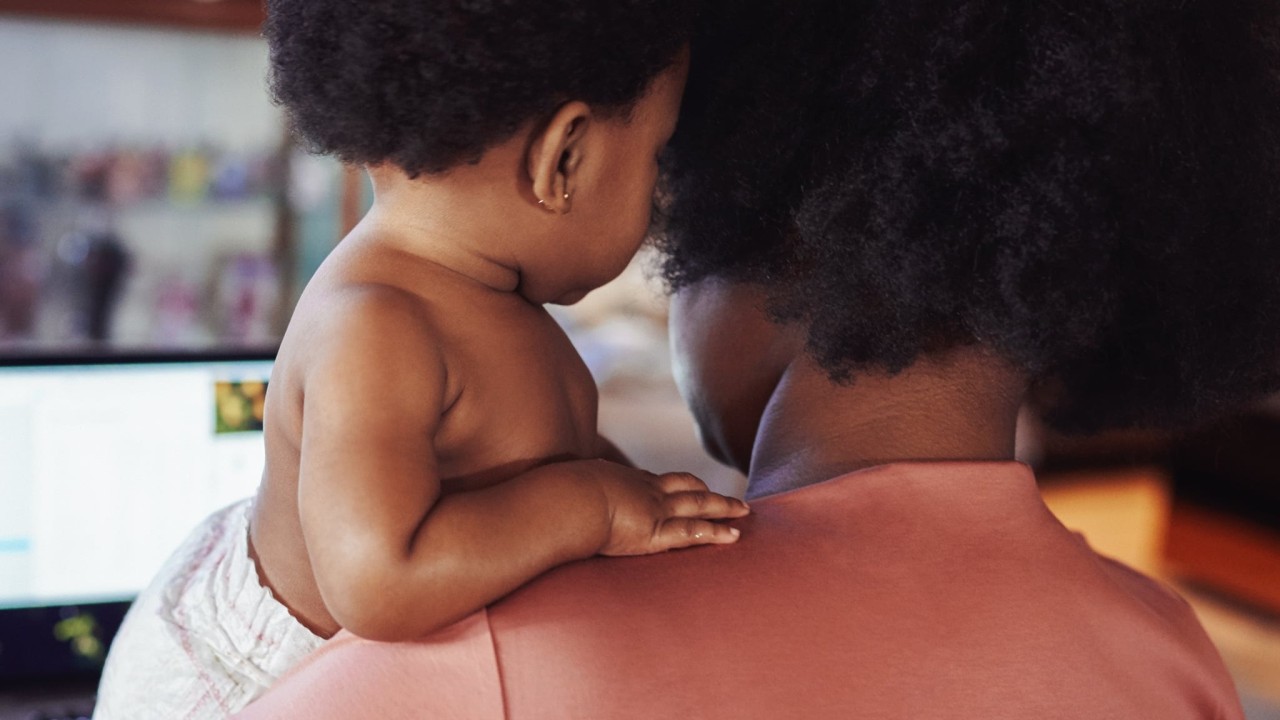 Image of a mom with a baby on her shoulder